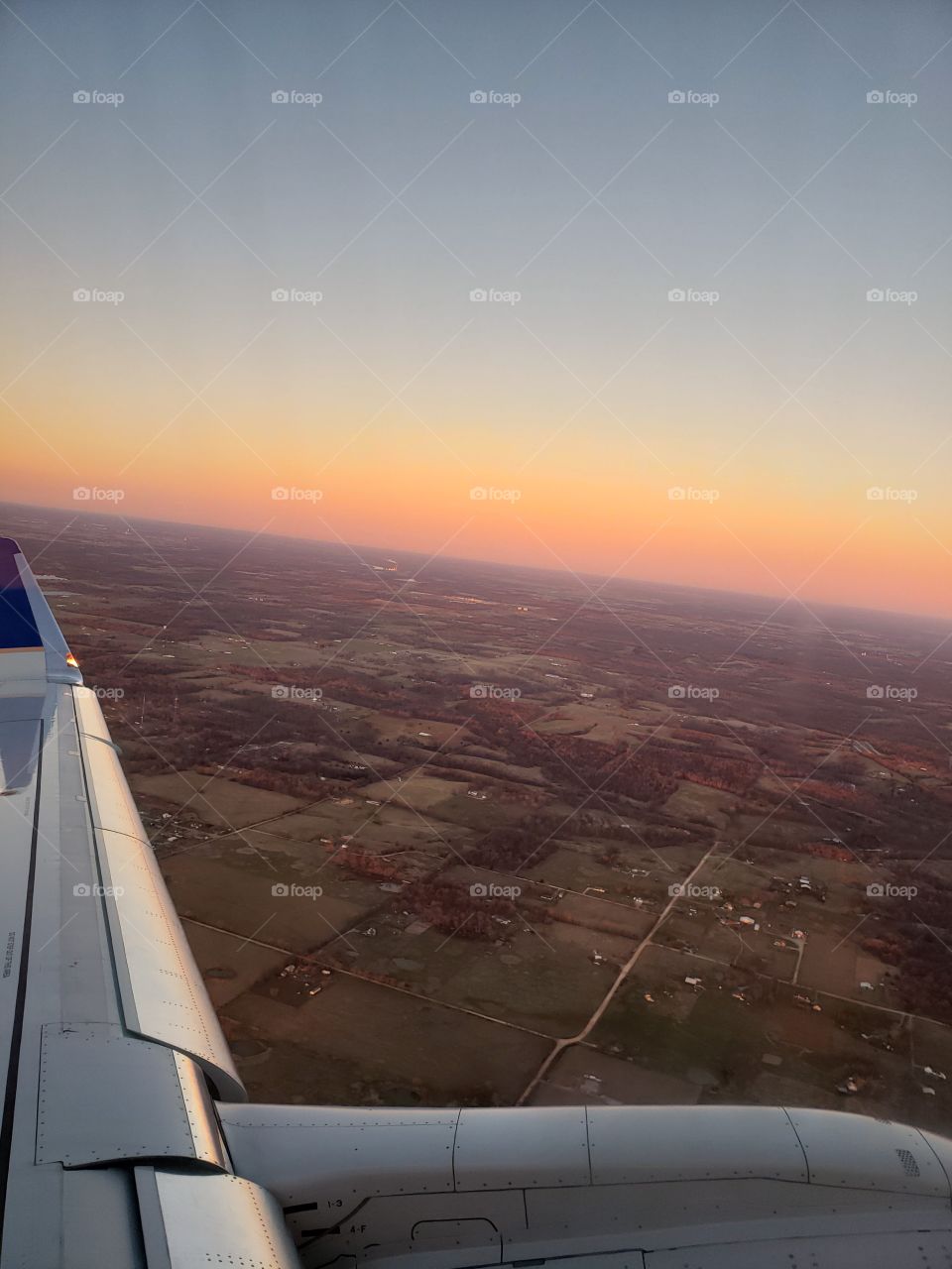 sunset over country from airplane