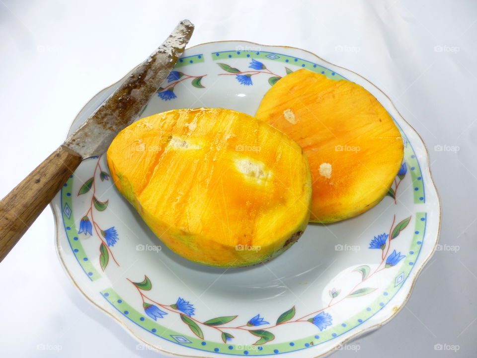 mango. yellow mangoes on the white plate
