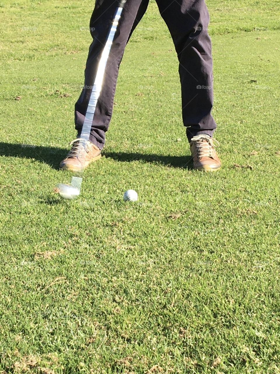 Playing golf with a club in action 
