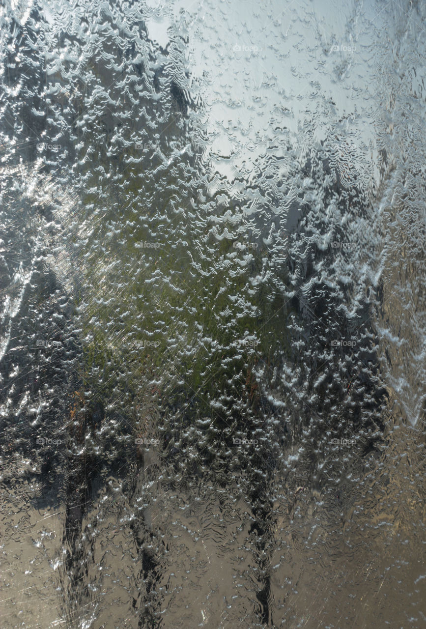 Running down stream of water in the metallic fountain in Cardiff Bay, Cardiff