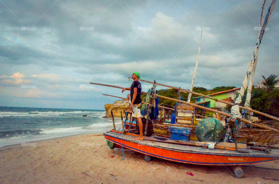 Man on boat looking at sea . Canoa Quebrada, Brazil 