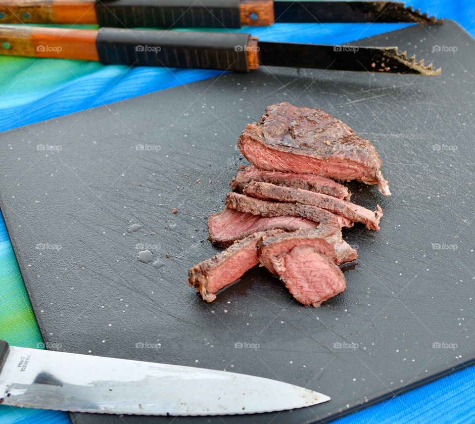Juicy medium rare steak on a cutting board ,sliced.