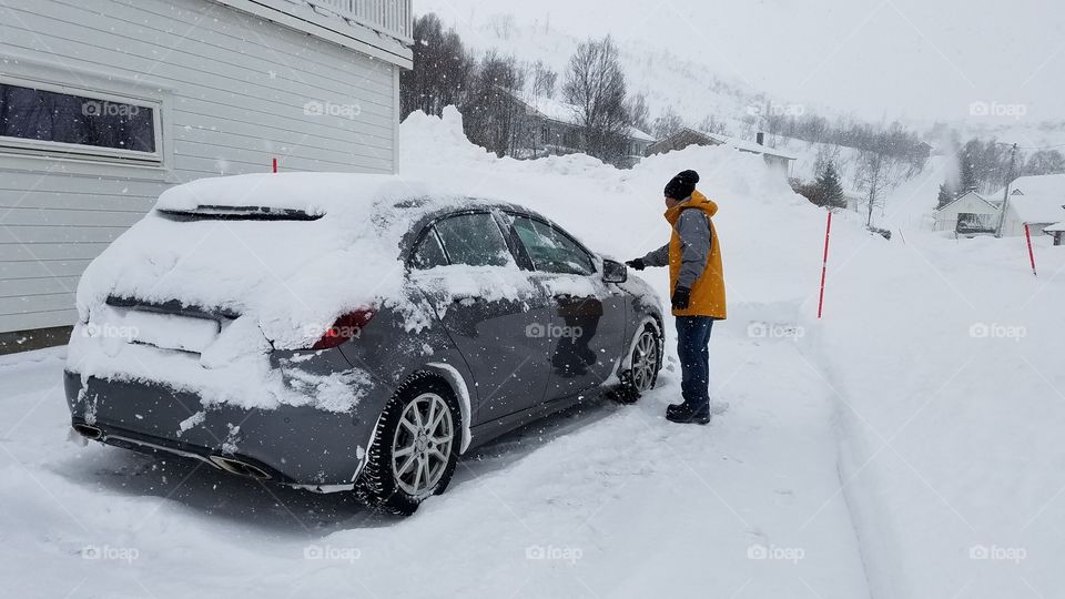 Scrapping snow off the car