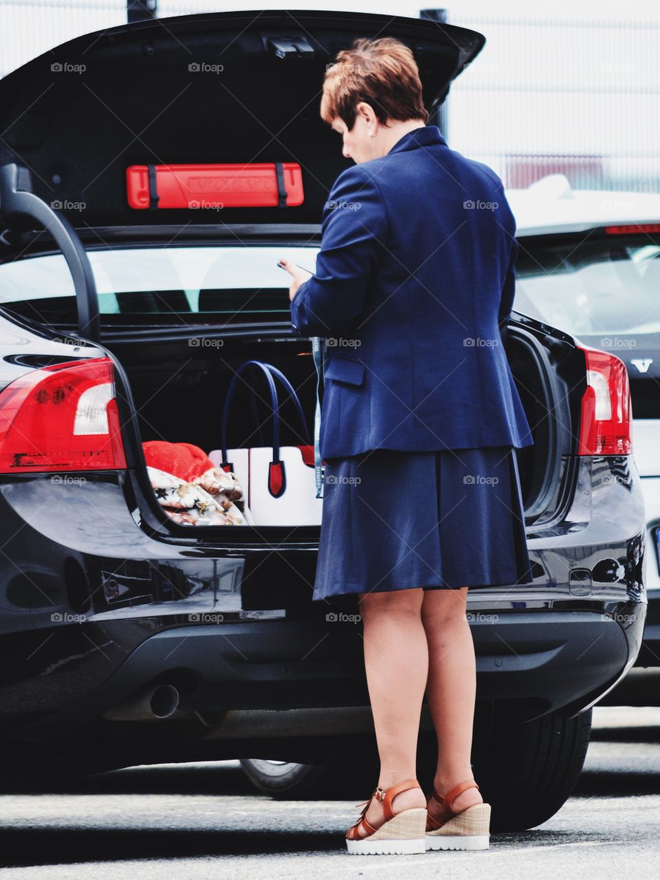 Woman in a suit with her phone