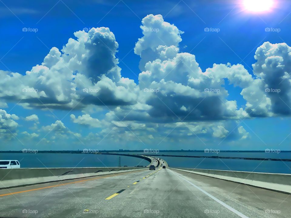 The Skyway bridge on sunny day with heavy cumulous clouds.