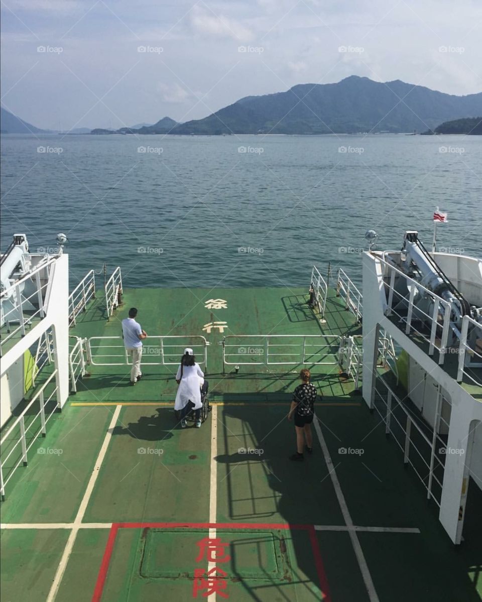 People on a boat heading to rabbit island in japan