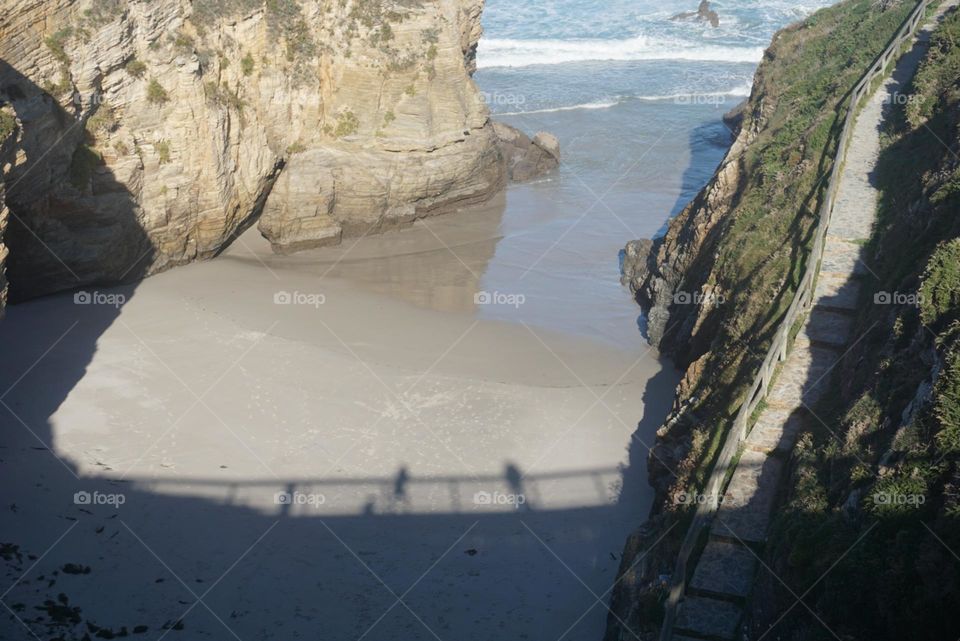 Beach#rocks#ocean#silhouette#bridge#humans