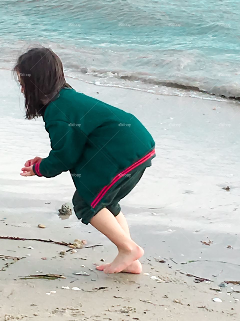 Young girl playing on beach alone south Australia 