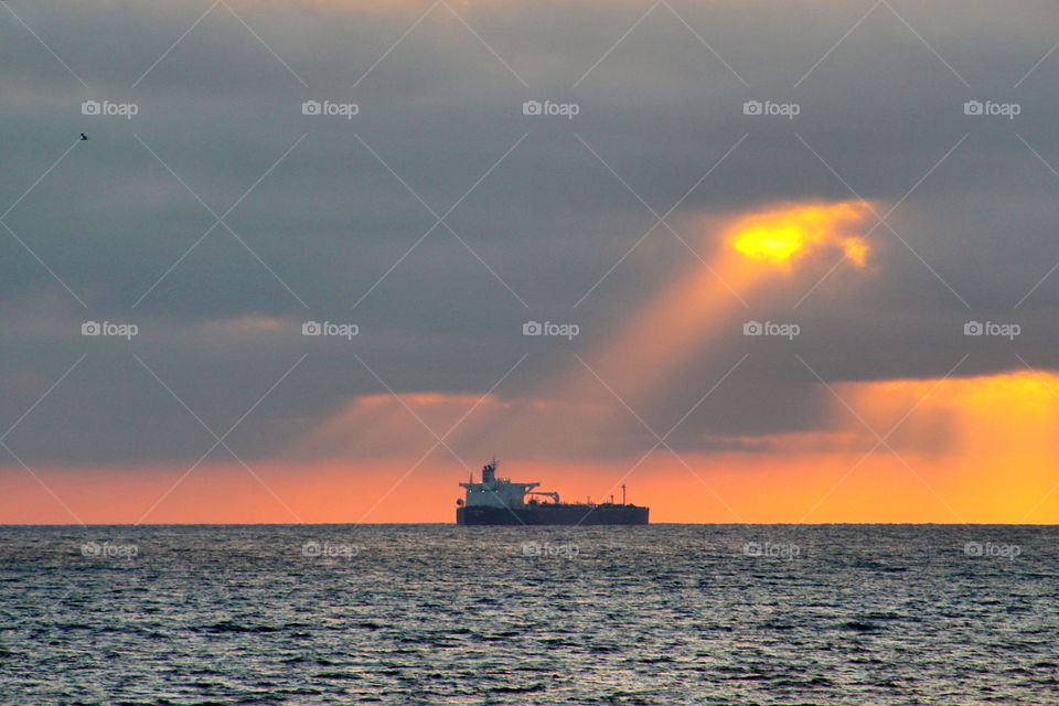 Boat in sea at sunset