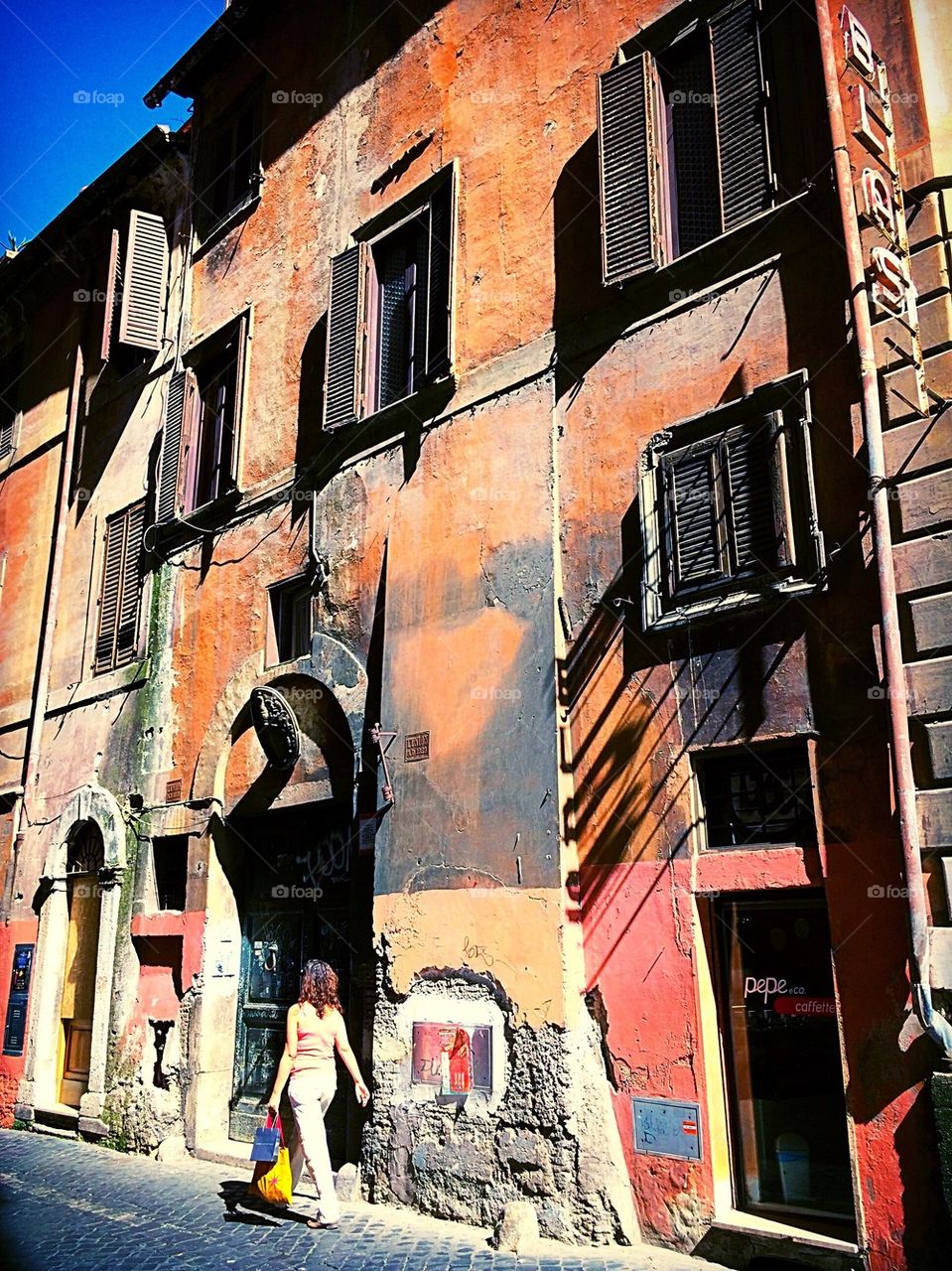 Lady walking Rome alleyway 