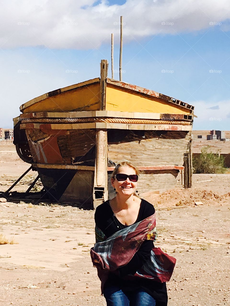 Smiling woman standing in front of preparing boat