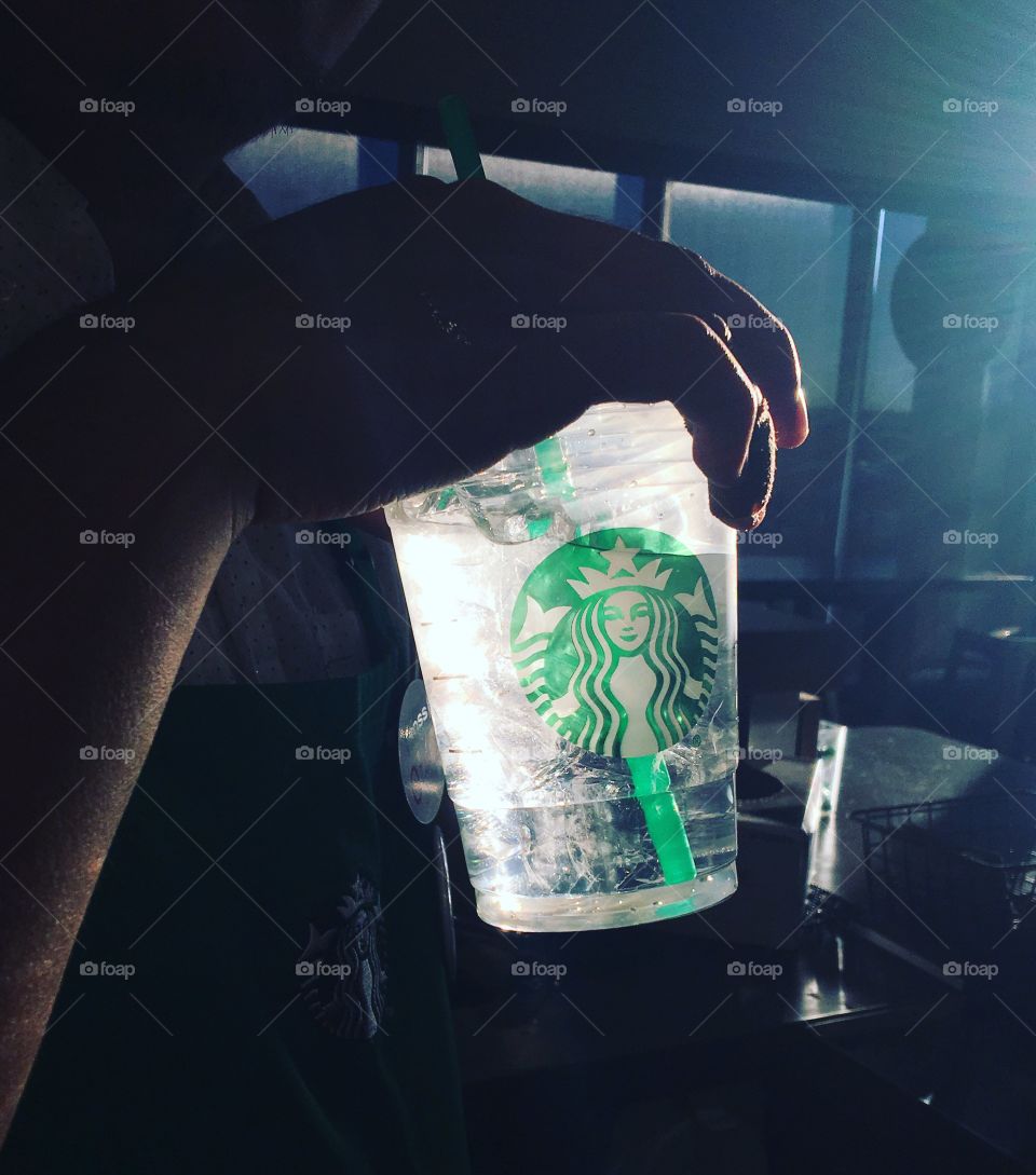 sunlight through a Starbucks water cup 
