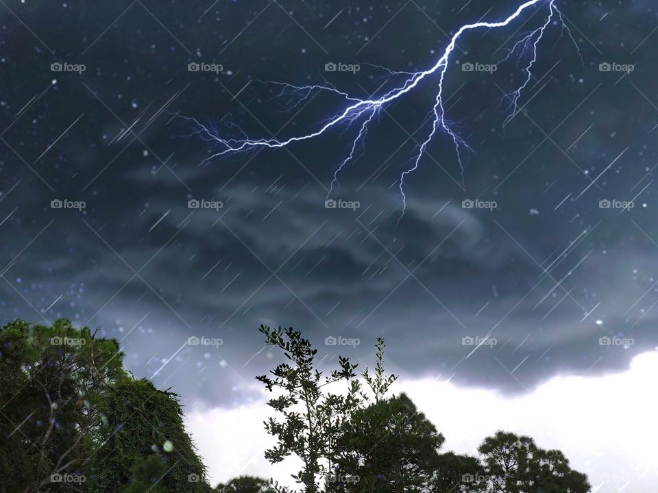 Lightning strikes black clouds and rain.