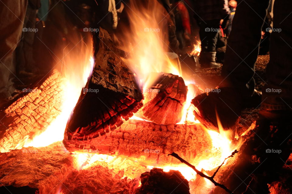 Fire and glowing logs at night