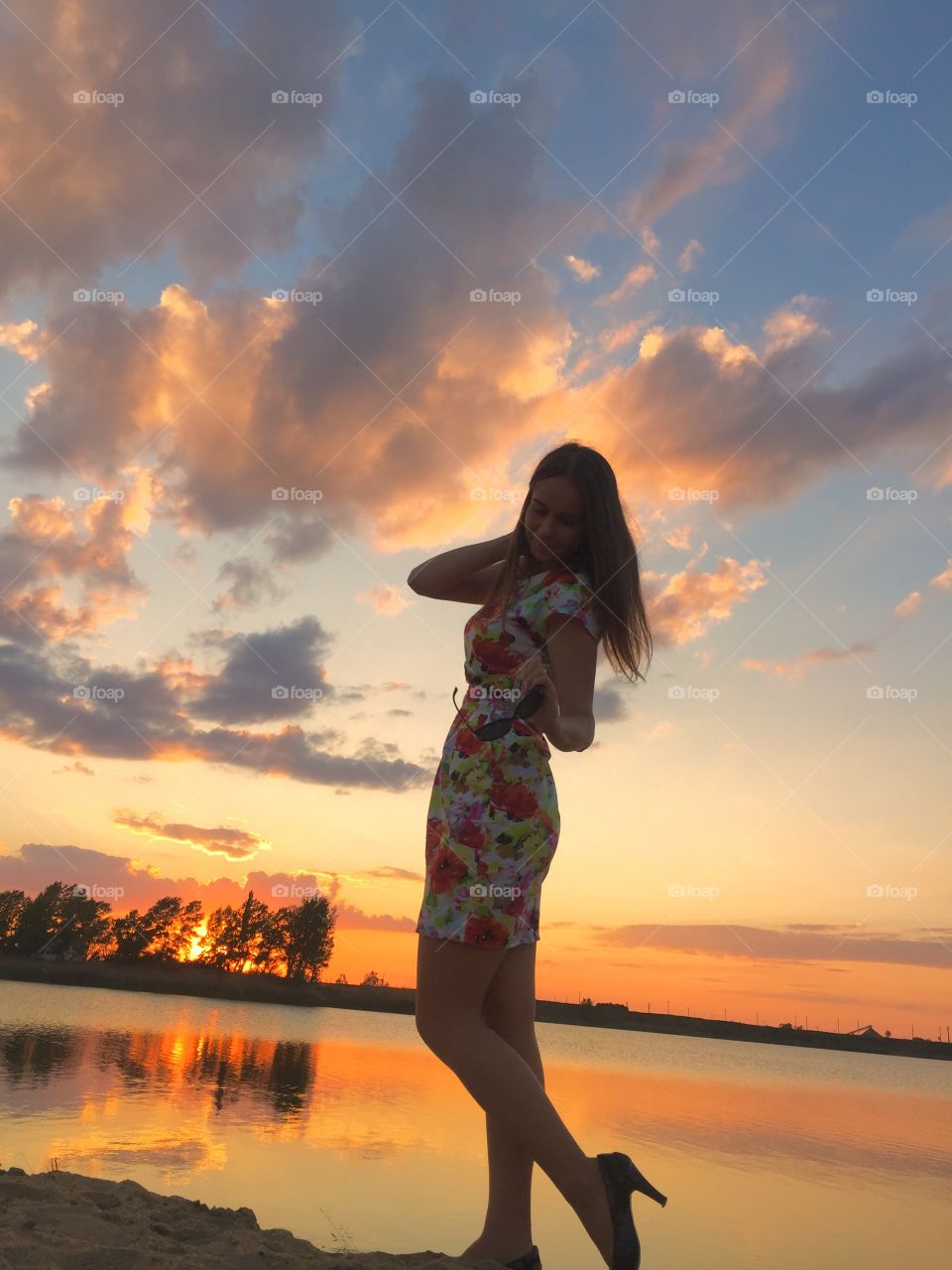 Woman posing near lake