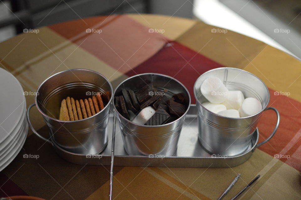 Making s'mores tray with dark chocolate pieces on table high angle view with marshmallows and graham crackers a traditional summertime fun treat 