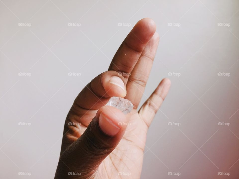 Close-up of person's hand holding rock sugar