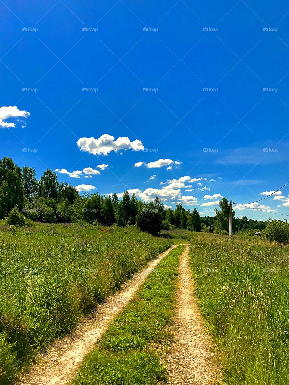 road with clouds on a summer day
