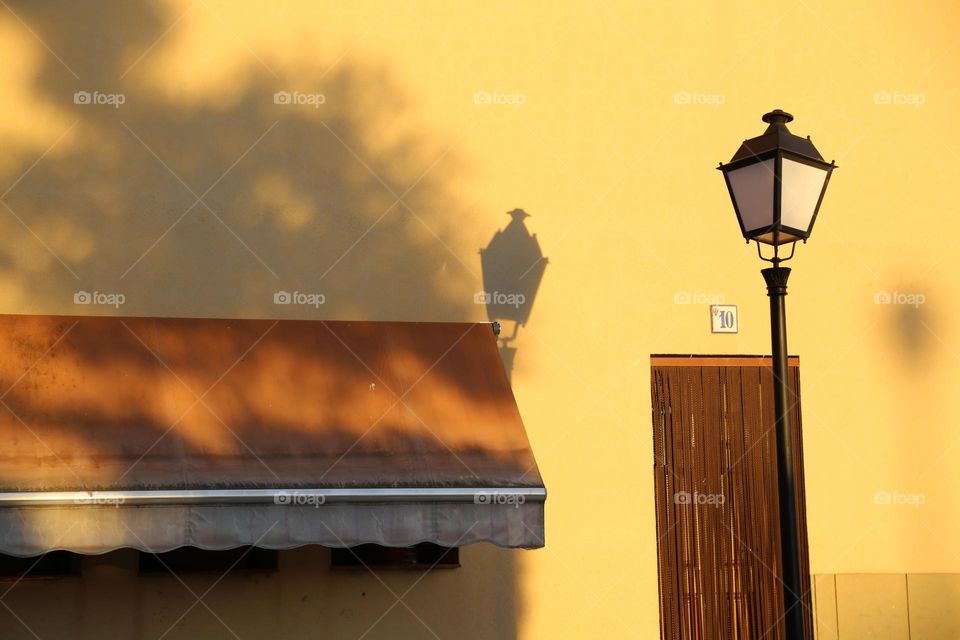 Sunshine in golden yellow on a wall