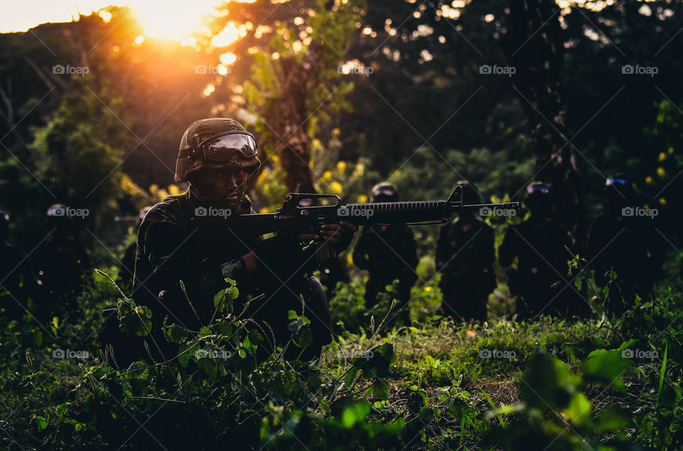 Soldiers with sun set in the jungle.