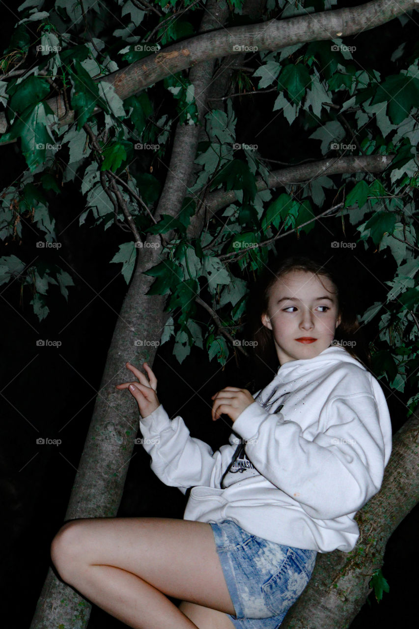 girl in a tree at night