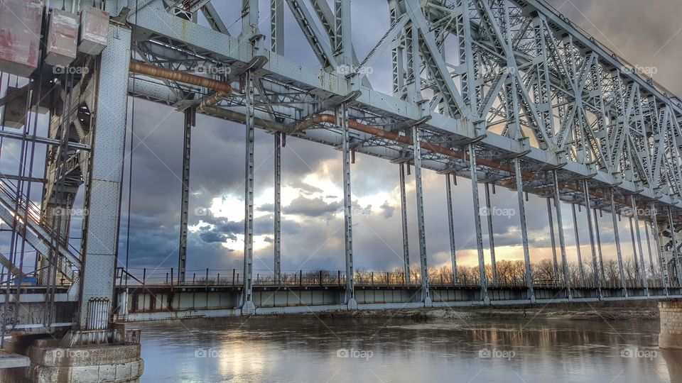 Setting Sun through bridge