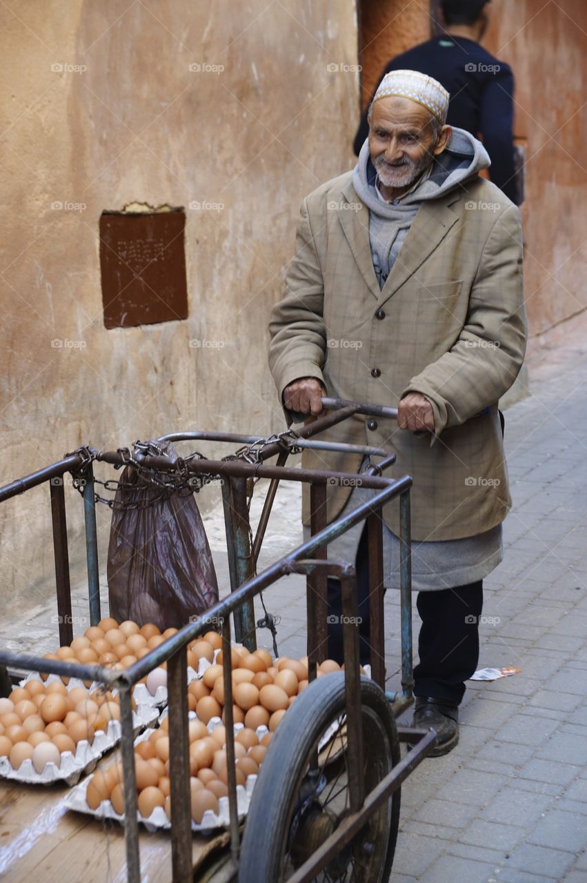 An old man selling eggs