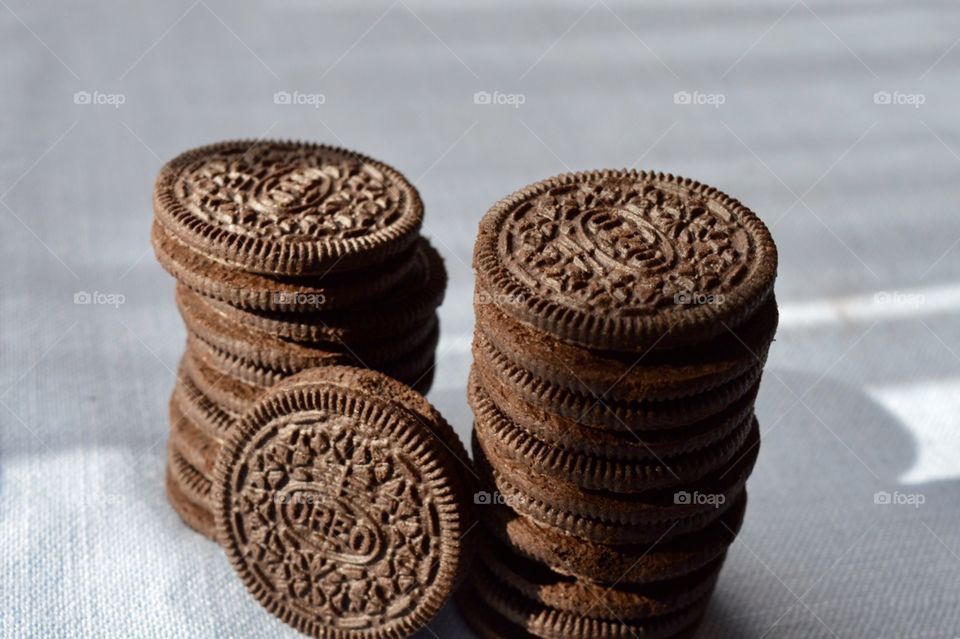 A stack of Oreo cookies on a blue background
