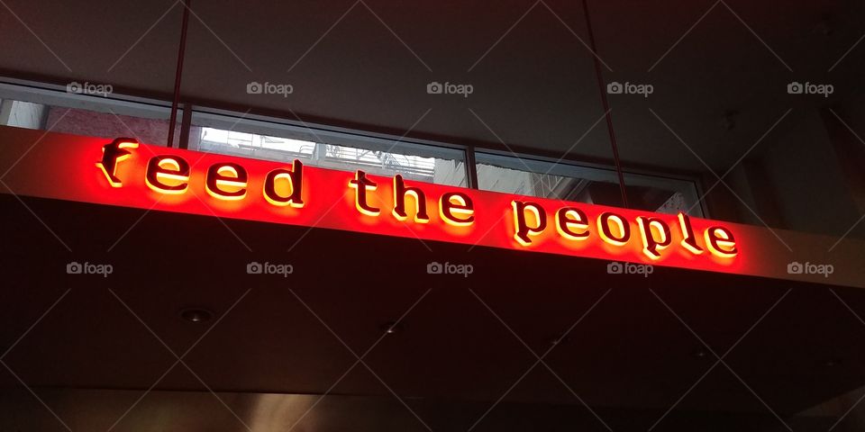 sign feed the people at restaurant credo