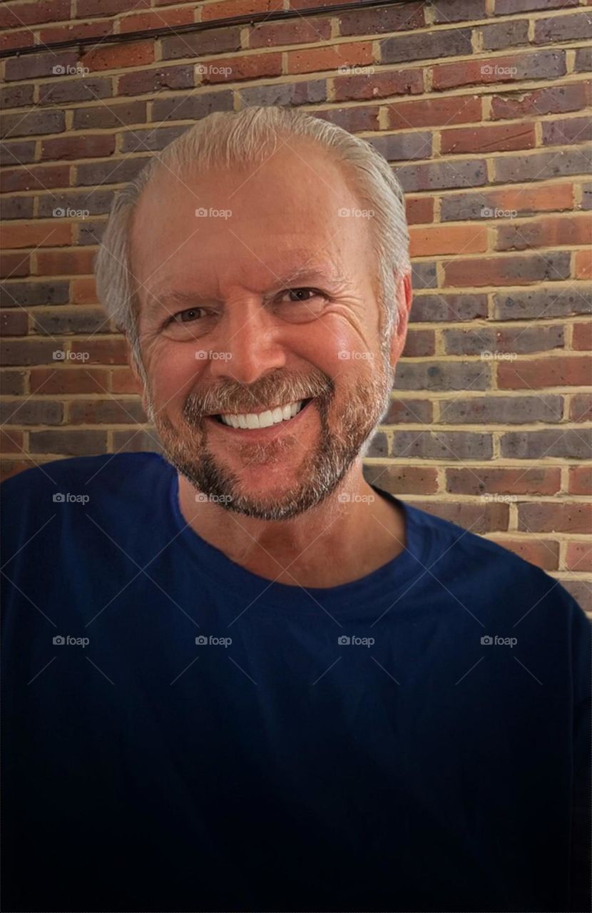 Smiling bearded man.