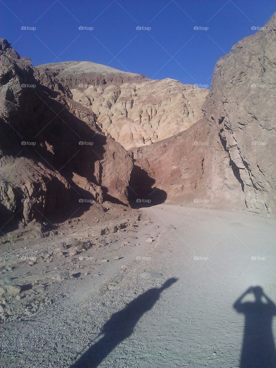 Human Shadows in Canyon. During the sunset, two human shadows inside a Death Valley canyon.