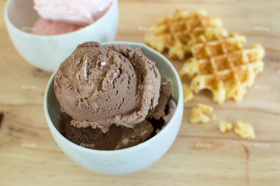 Chocolate ice cream scoops and strawberry ice cream