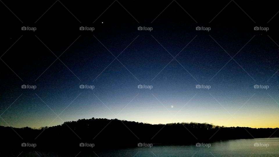 Dusk on the lake with a sliver of a moon and star