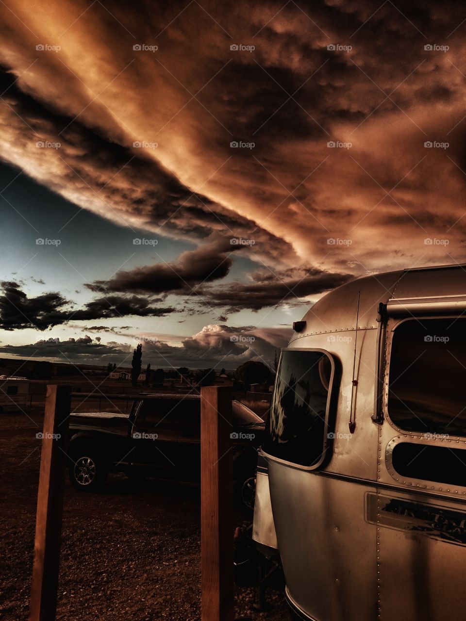 Vintage Airstream after the storm, under apocalyptic skies.