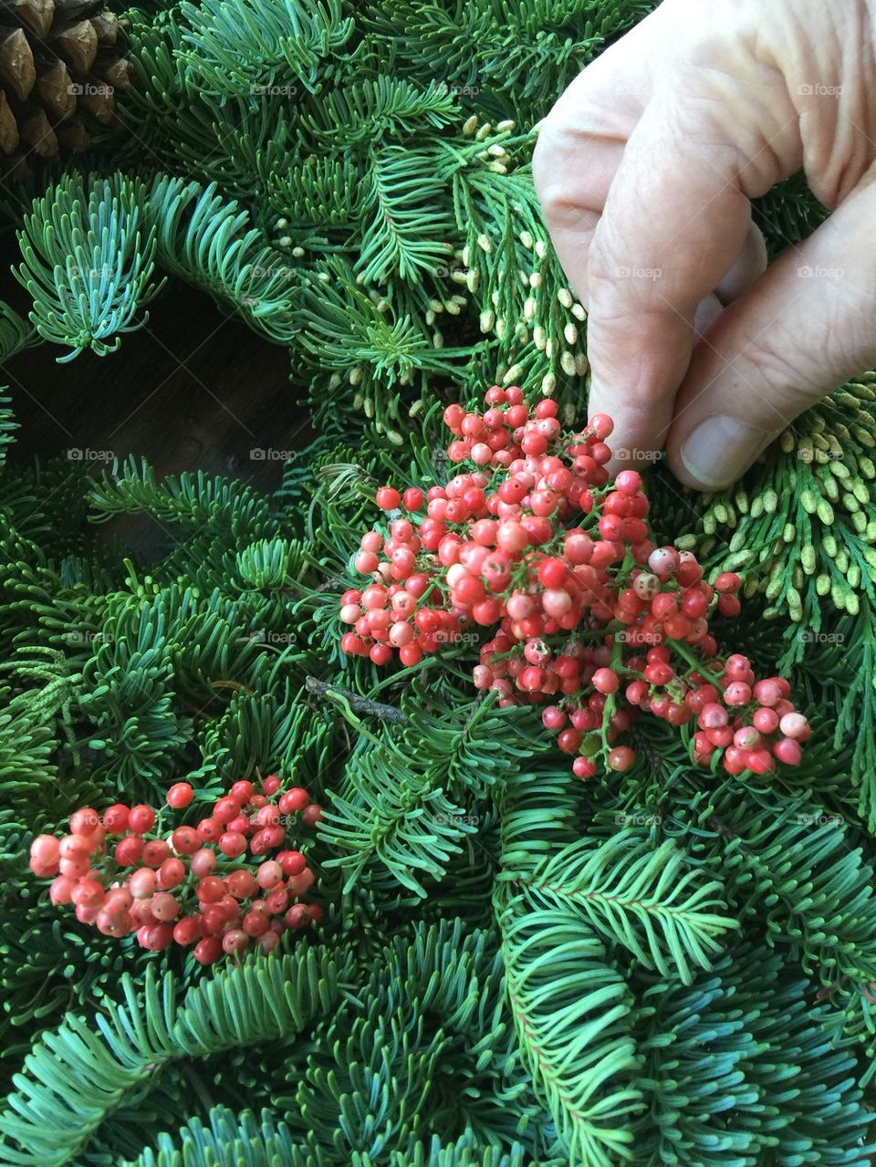 Decorating wreath with berries