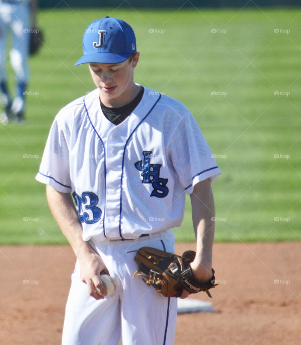 Teenager baseball player at field