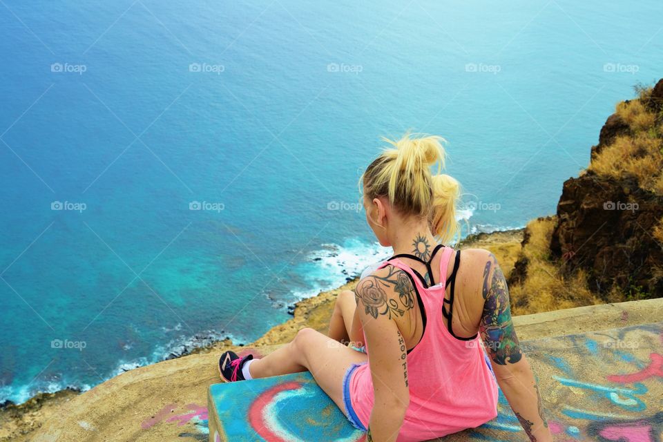 My daughter and I at the west side pillbox hike on Oahu overlook the gorgeous turquoise waters 