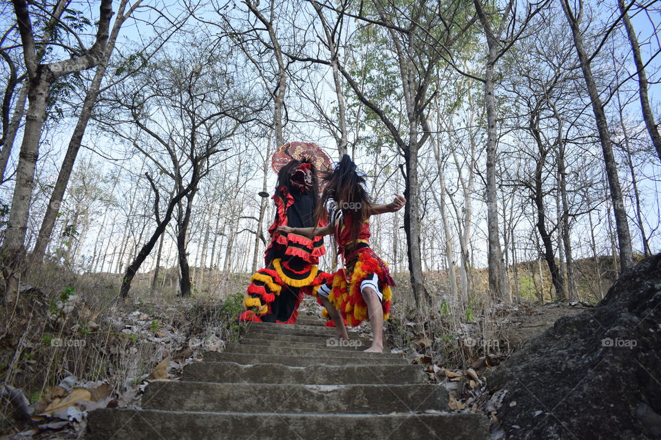 Bujang Ganong and Barongan on red color dresses