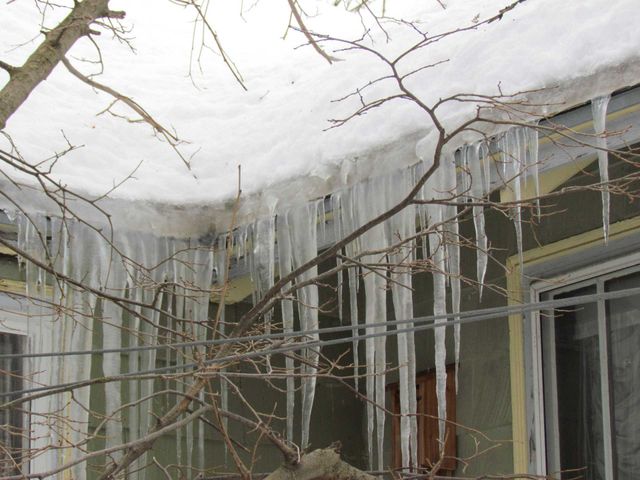 Icicle hanging on house roof