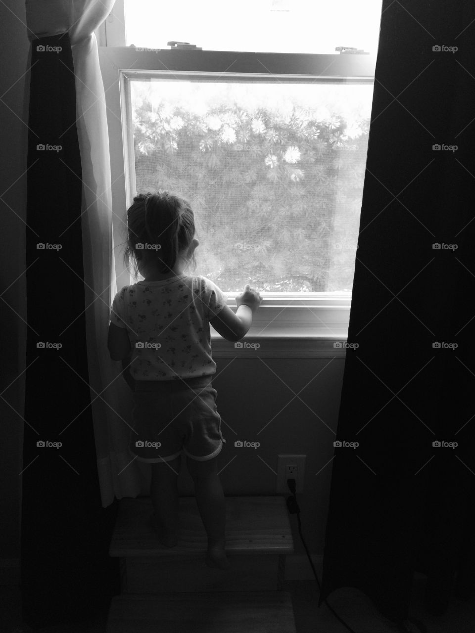 Little girl looking out the window 