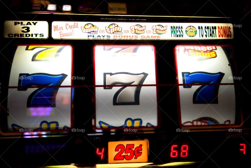 Slot machine showing triple sevens