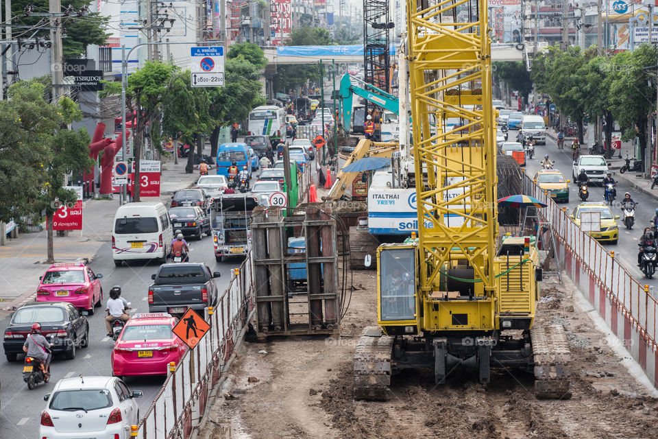 Construction crane of the BTS public train on the road with traffic jam in Bangkok Thailand 