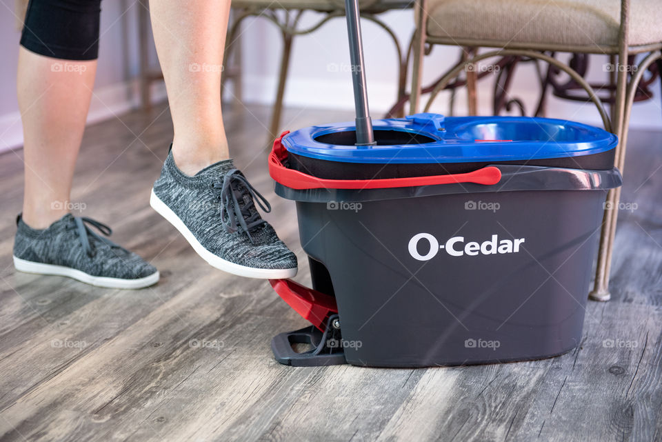 Person using an O-Cedar mop and bucket 