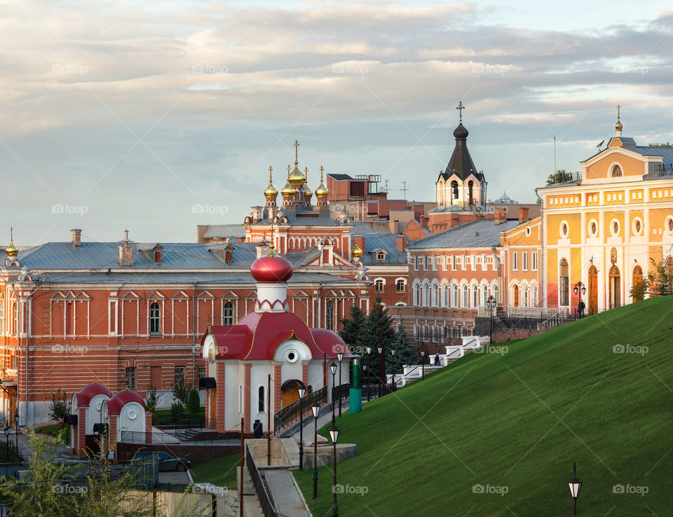 Buildings and temples of the monastery (Russia, Samara) under a cloudy sky on a sunny autumn day