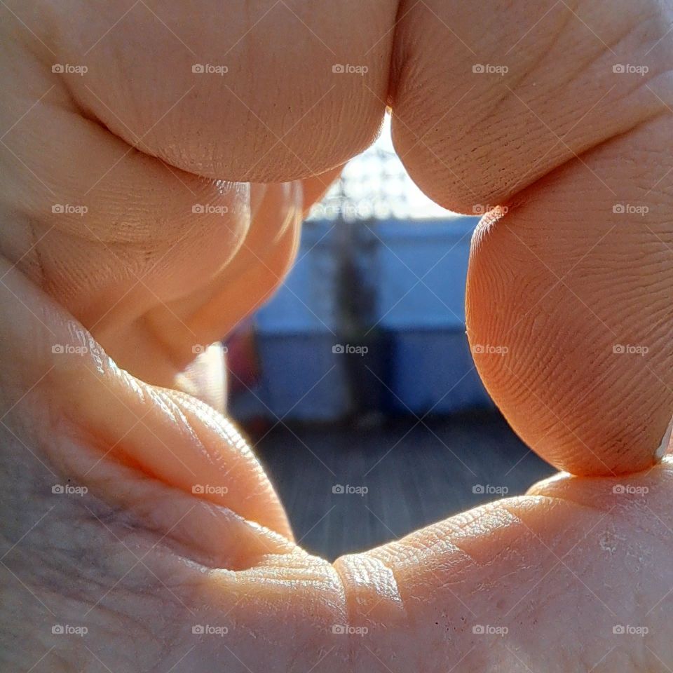 skin, fingers in circle, close up, sunlight