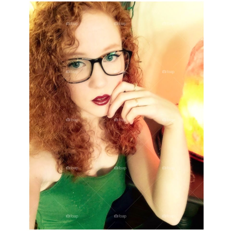 Natural redhead with curly hair and glasses