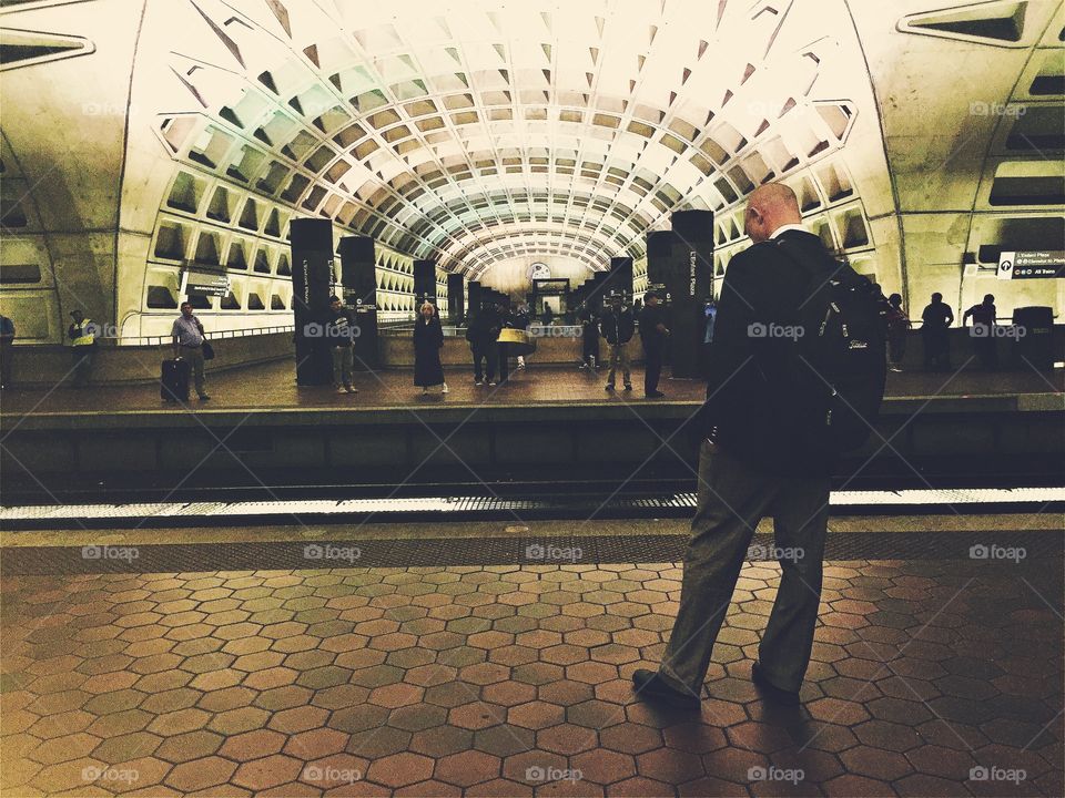 Men waiting standing in a subway station in Washington DC