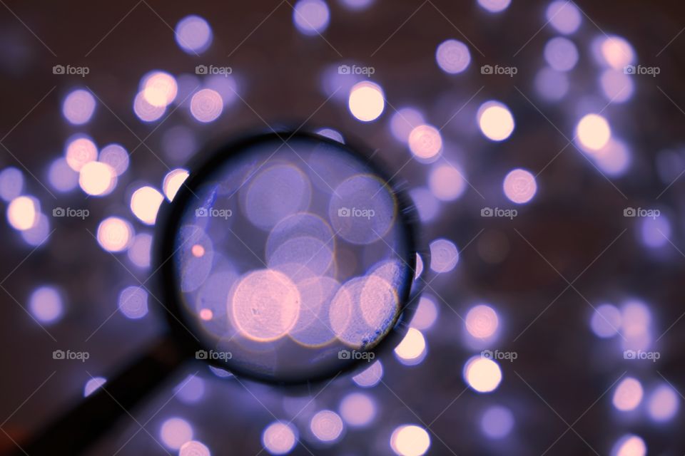 Flash night illuminated magnifying glass light close-up celebration decoration textured blur luxury background purple color