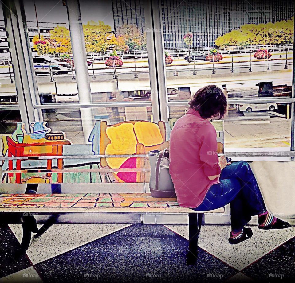 Woman in pink sitting in an art installation.