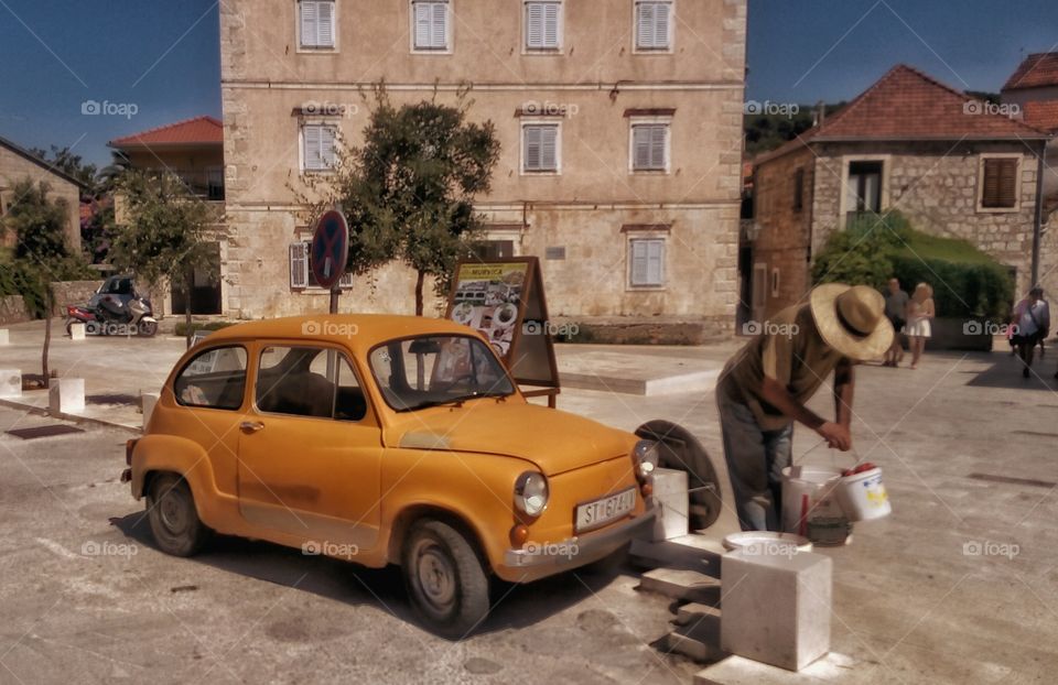 Old man and cute vintage car in Jelsa, Croatia